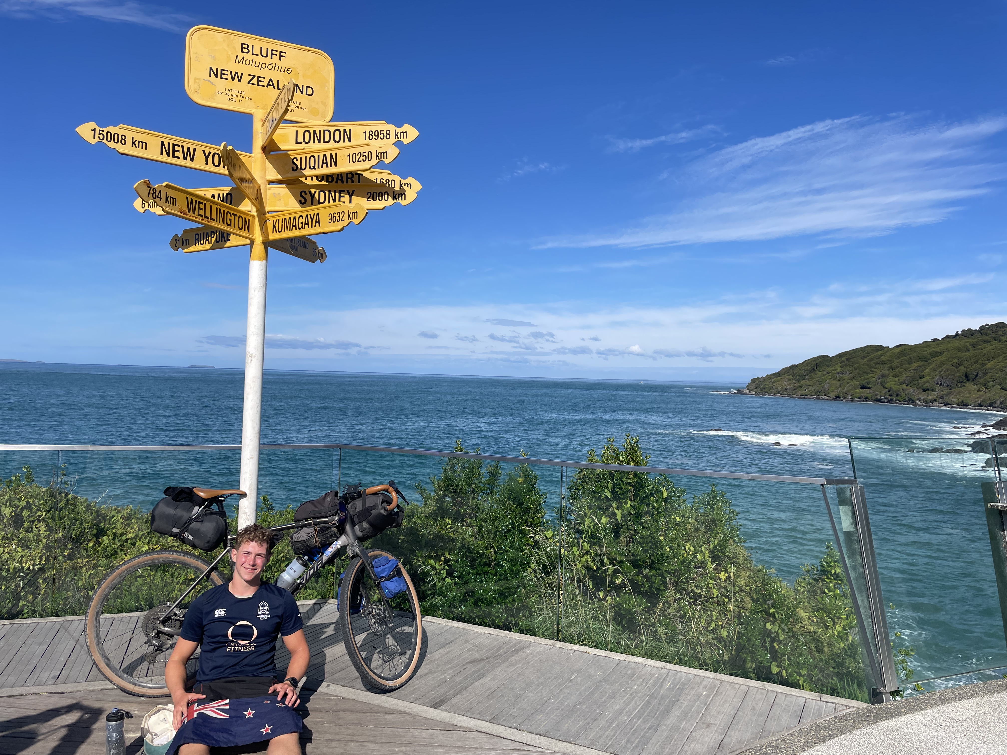 Tom at Stirling Point, Bluff, the southernmost tip of New Zealand, at the end of his ride the length of the country