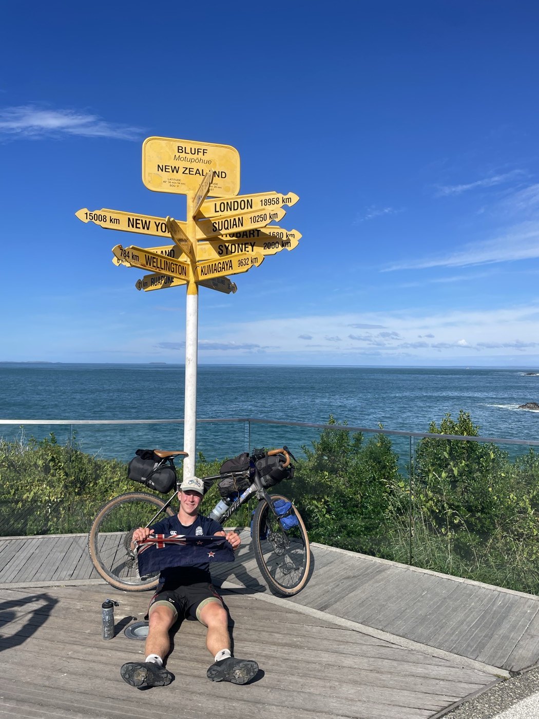 Tom at Stirling Point, Bluff, the end of his ride the length of New Zealand