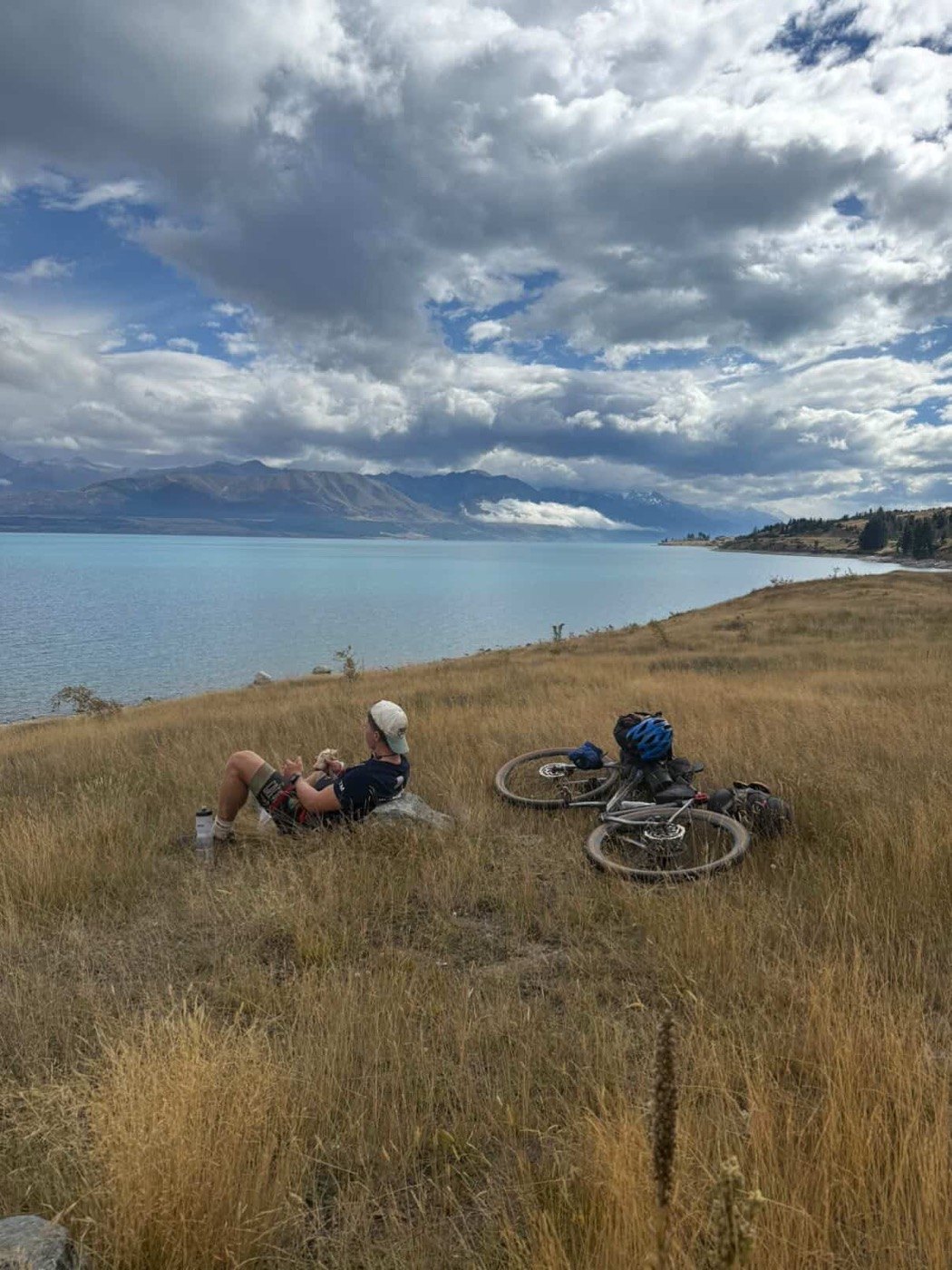Resting beside Lake Pukaki, New Zealand, bikes in the grass